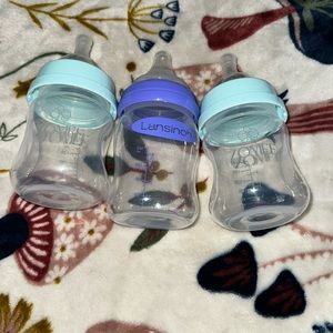 3 baby bottles, 2 zomee, 1 lansinoh NEVER USED